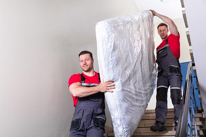 a box spring being taken out of a room during a move in Lillian